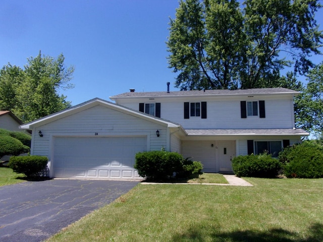 view of front of property featuring a front yard and a garage