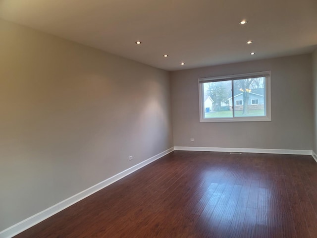 unfurnished room featuring dark wood-type flooring