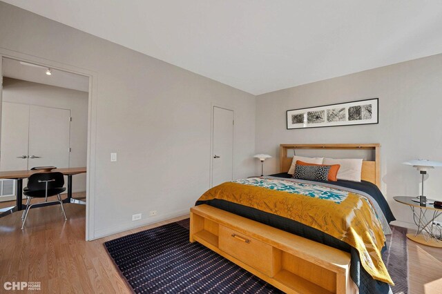 bedroom with hardwood / wood-style flooring