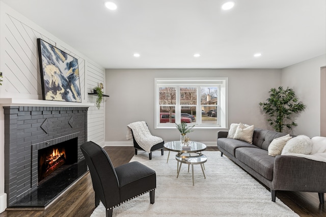 living room with hardwood / wood-style flooring and a fireplace