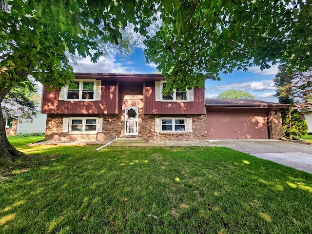 split foyer home featuring a garage and a front lawn