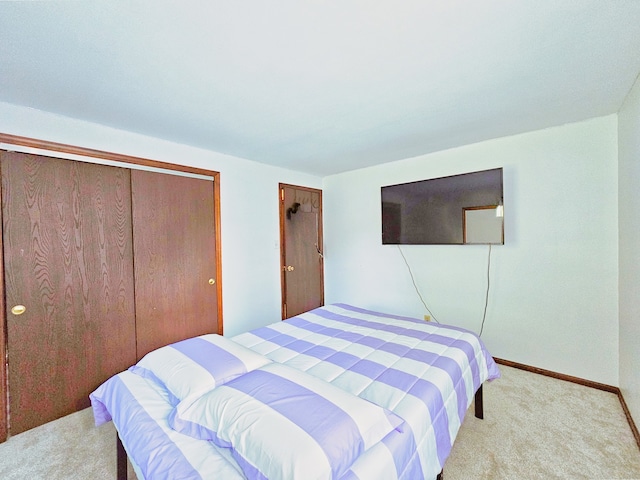 carpeted bedroom featuring a closet