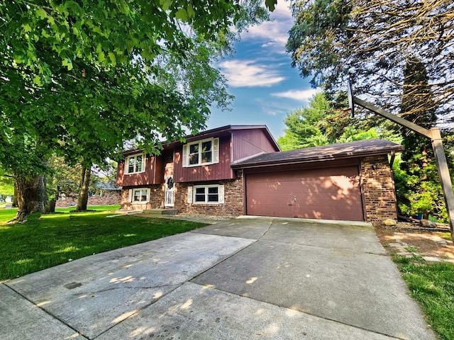 bi-level home with a garage and a front lawn