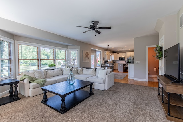 living room featuring ceiling fan and light wood-type flooring