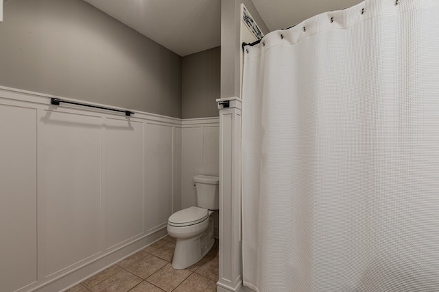 bathroom with tile patterned floors and toilet