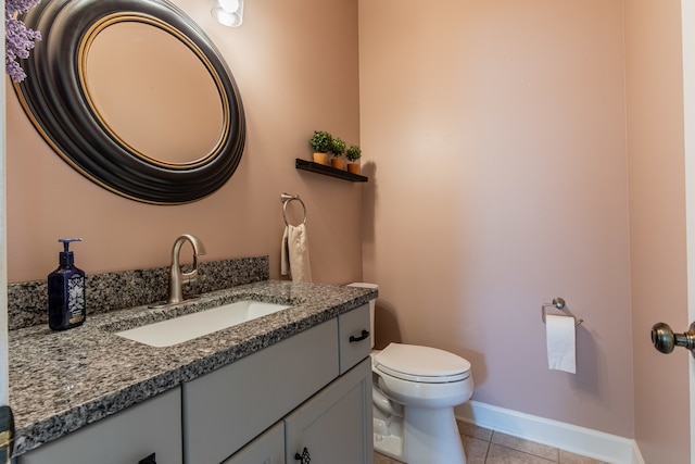 bathroom with tile patterned flooring, vanity, and toilet