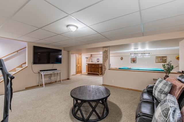 carpeted living room with a paneled ceiling