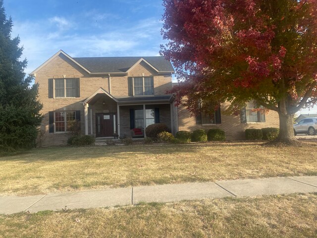 view of front of property with a front yard and a porch