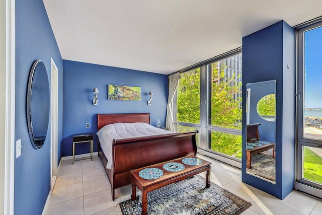 tiled bedroom featuring floor to ceiling windows