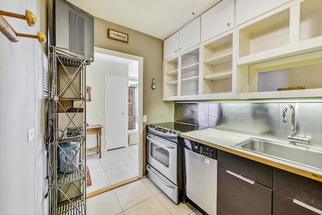 kitchen with sink, white cabinetry, stainless steel appliances, dark brown cabinetry, and light tile patterned flooring