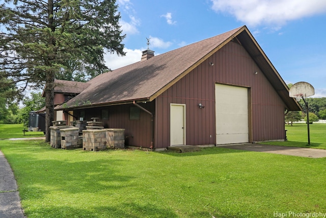 exterior space featuring a garage and a lawn