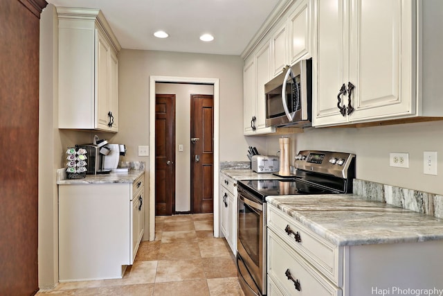 kitchen with appliances with stainless steel finishes and light tile patterned floors