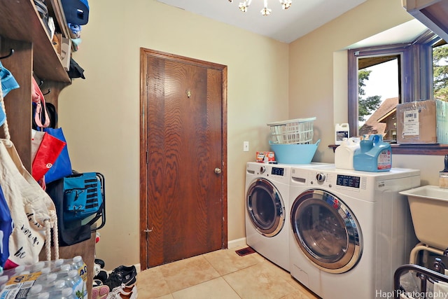 laundry area featuring washer and clothes dryer and light tile patterned floors