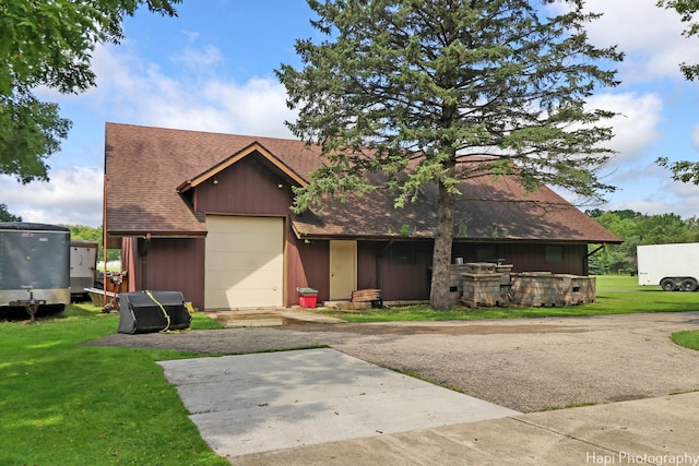 view of front of property with a garage and a front lawn