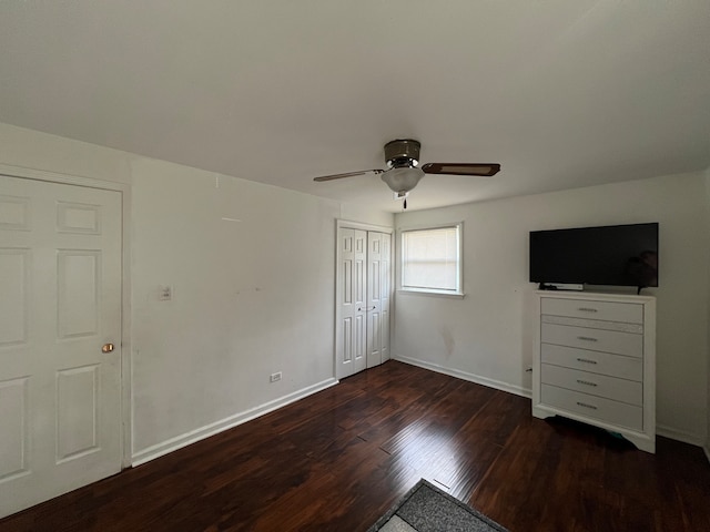 unfurnished bedroom featuring ceiling fan and dark wood-type flooring