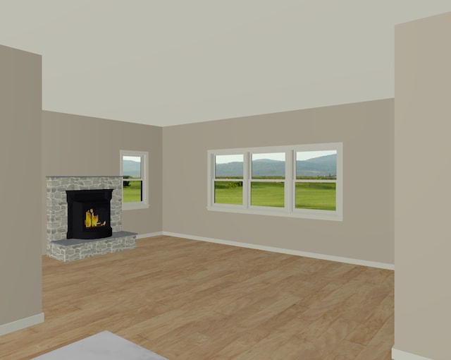 unfurnished living room with light wood-type flooring and a brick fireplace