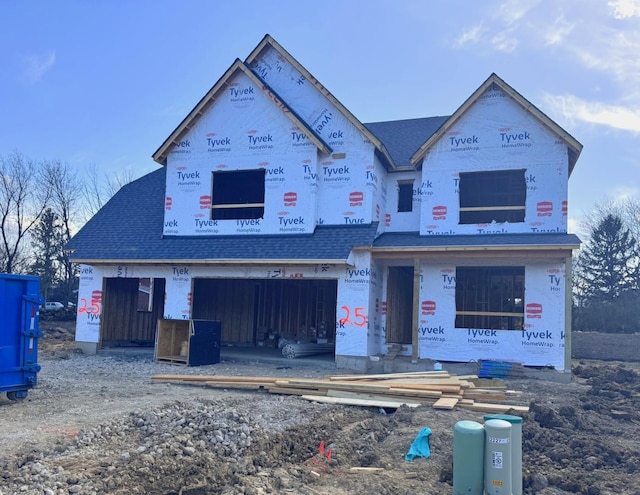property in mid-construction featuring a shingled roof and a garage