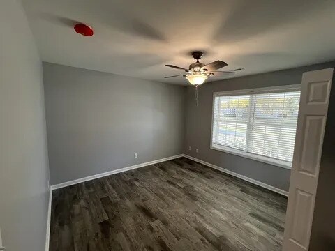 1109 S 2nd St, Oregon, IL 61061 - spare room with dark wood-type flooring and ceiling fan