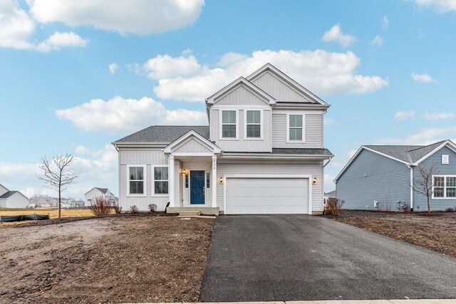 view of front of property with a garage and a front lawn