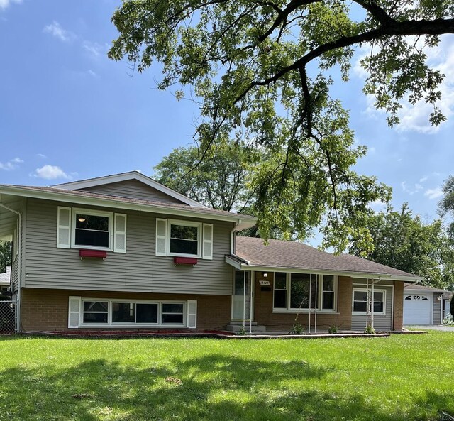 split level home with a garage and a front yard