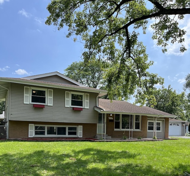 tri-level home with a garage and a front yard