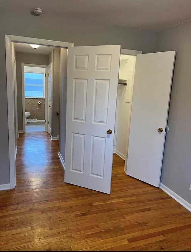 unfurnished bedroom with light hardwood / wood-style floors and a closet