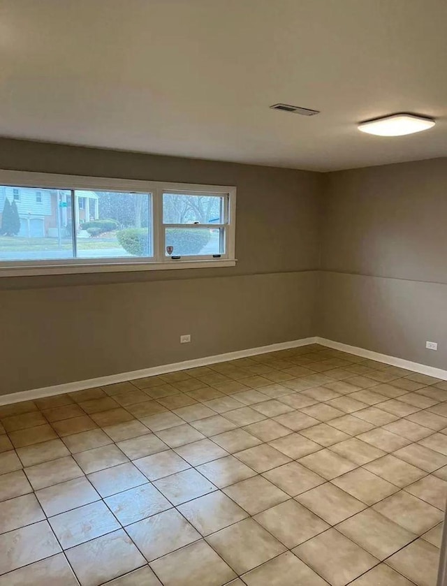 unfurnished room with light tile patterned floors