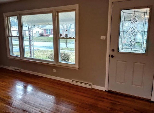 entryway featuring dark wood-type flooring, plenty of natural light, and a baseboard radiator