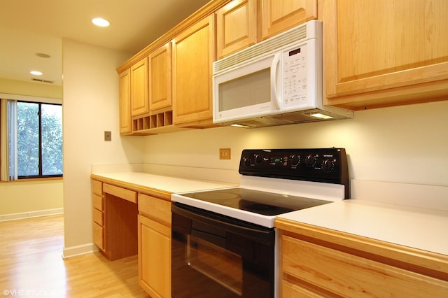 kitchen with light countertops, black electric range oven, built in study area, and white microwave