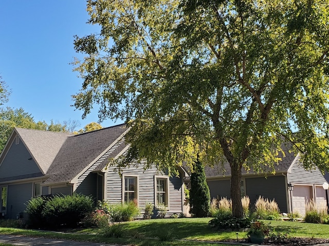 view of front facade with a garage and a front lawn