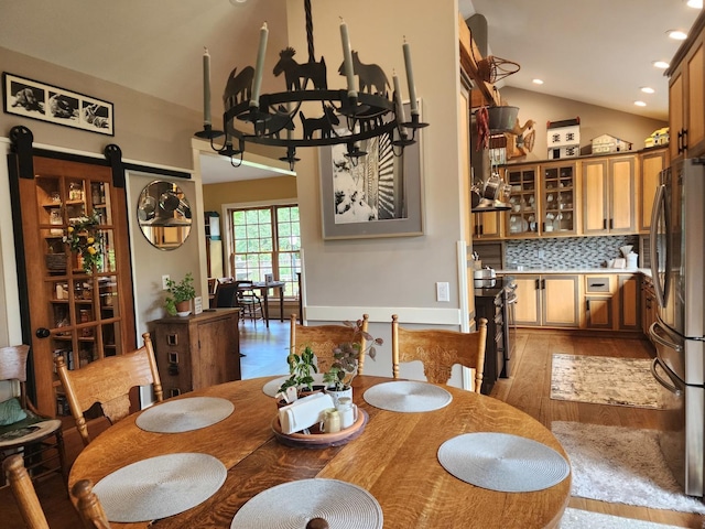 1726 Georgetown Dr, Champaign, IL 61821 - dining room with vaulted ceiling, light wood-type flooring, recessed lighting, a chandelier, and a barn door