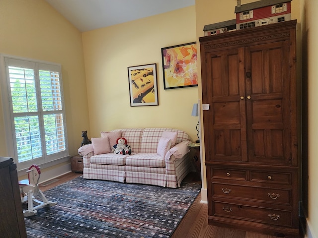 living room featuring vaulted ceiling and dark hardwood / wood-style floors