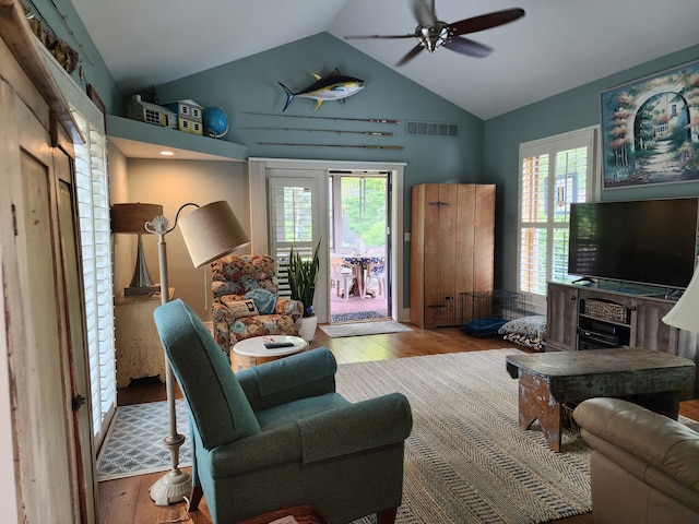 living room with lofted ceiling, light hardwood / wood-style flooring, and ceiling fan