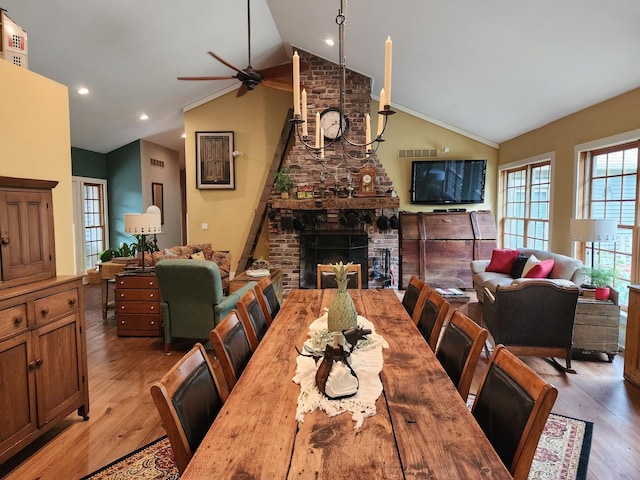 1726 Georgetown Dr, Champaign, IL 61821 - dining room featuring ceiling fan, lofted ceiling, a fireplace, and wood finished floors