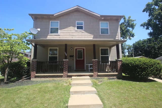 view of front of home with a porch and a front yard