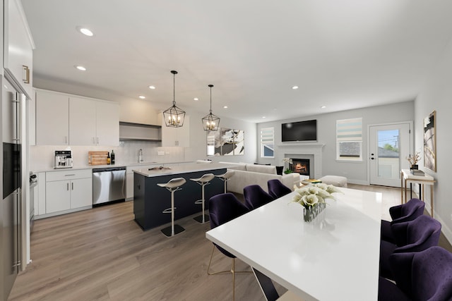 dining space featuring sink and light hardwood / wood-style flooring