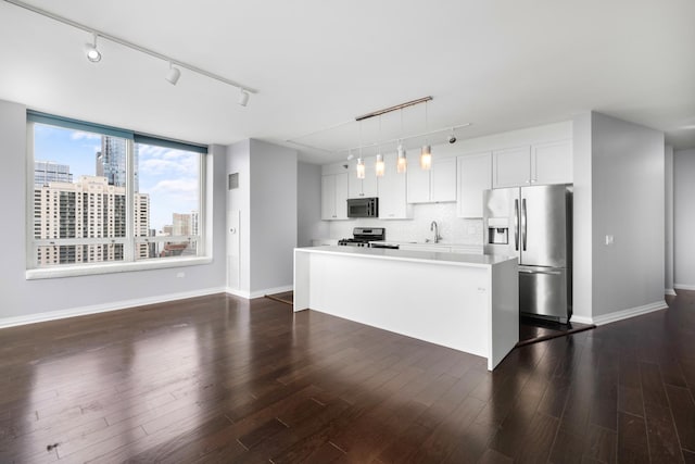 kitchen with decorative backsplash, dark wood-style floors, stainless steel appliances, light countertops, and white cabinetry