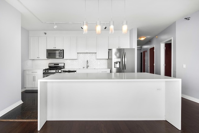 kitchen with white cabinetry, stainless steel appliances, a sink, and light countertops