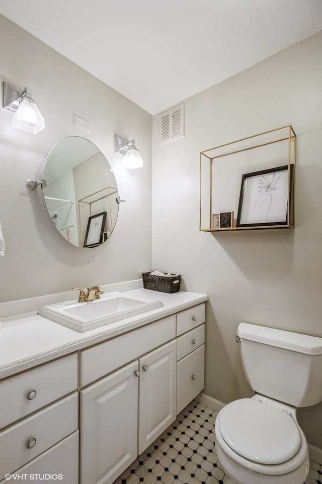 bathroom featuring tile patterned floors, toilet, and vanity