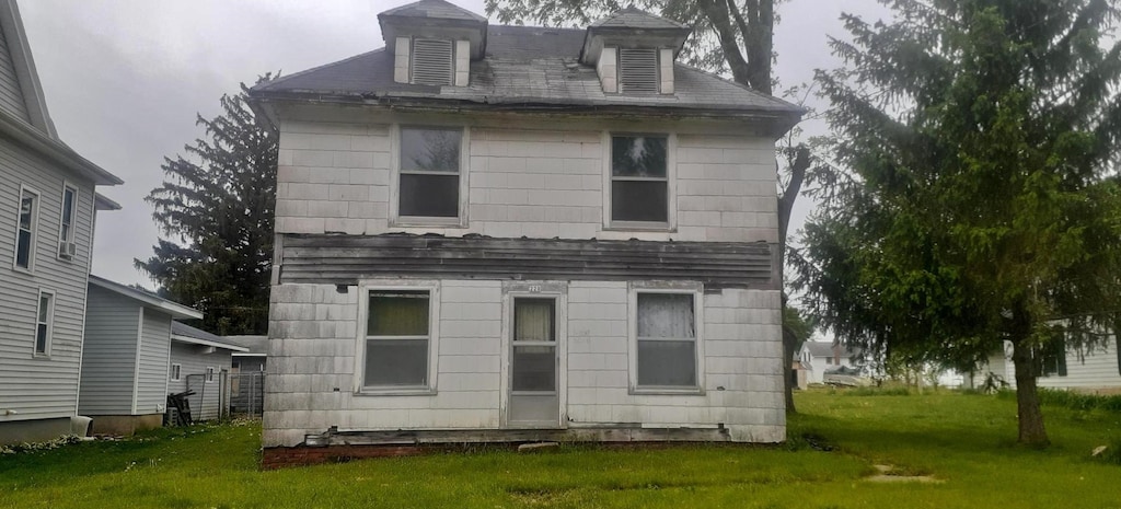 rear view of house with a lawn