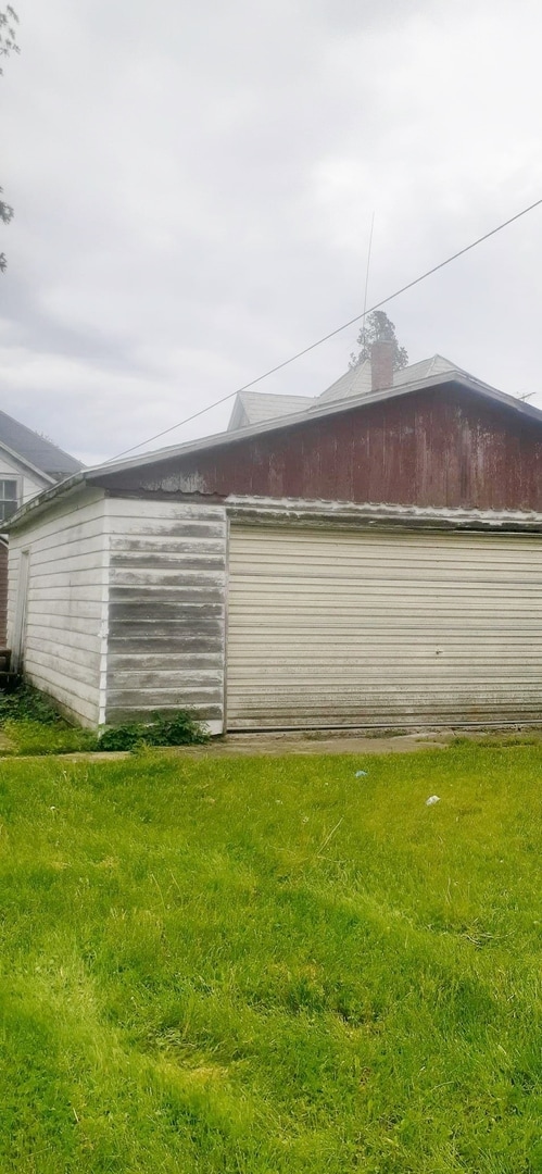 view of side of property with a yard