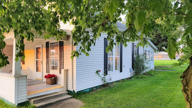 view of side of home with a yard