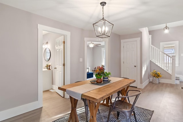 dining space with light hardwood / wood-style flooring and ceiling fan