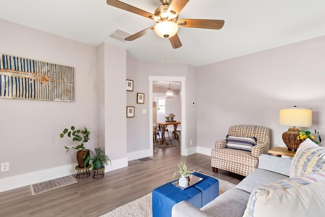 living room featuring ceiling fan and wood-type flooring