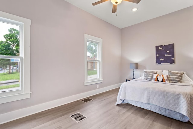 bedroom with ceiling fan and light wood-type flooring