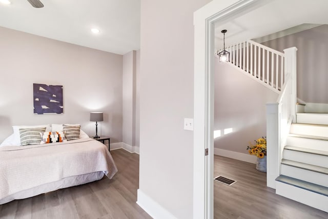 bedroom featuring hardwood / wood-style flooring and ceiling fan