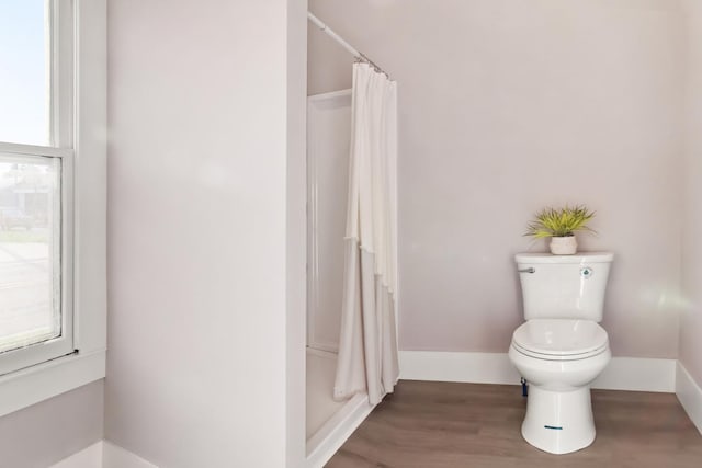 bathroom featuring toilet and a shower with shower curtain