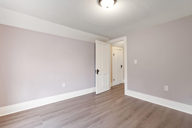 empty room with light hardwood / wood-style flooring