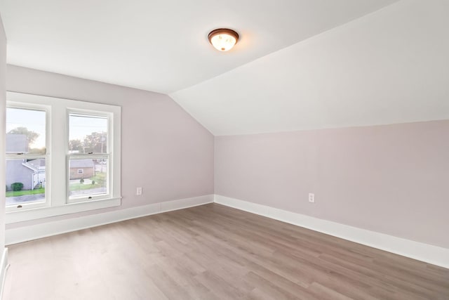 additional living space featuring hardwood / wood-style flooring and lofted ceiling