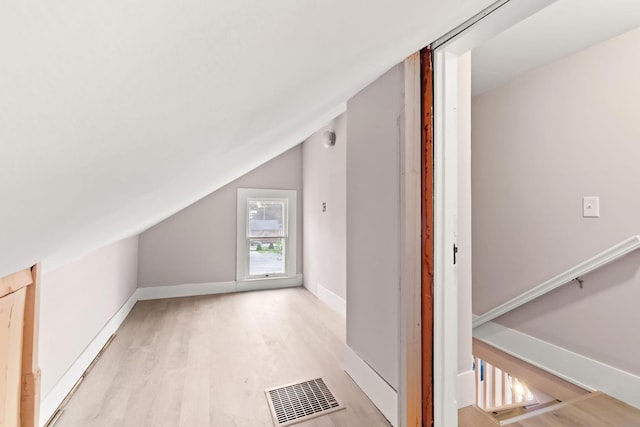 bonus room with lofted ceiling and light hardwood / wood-style flooring